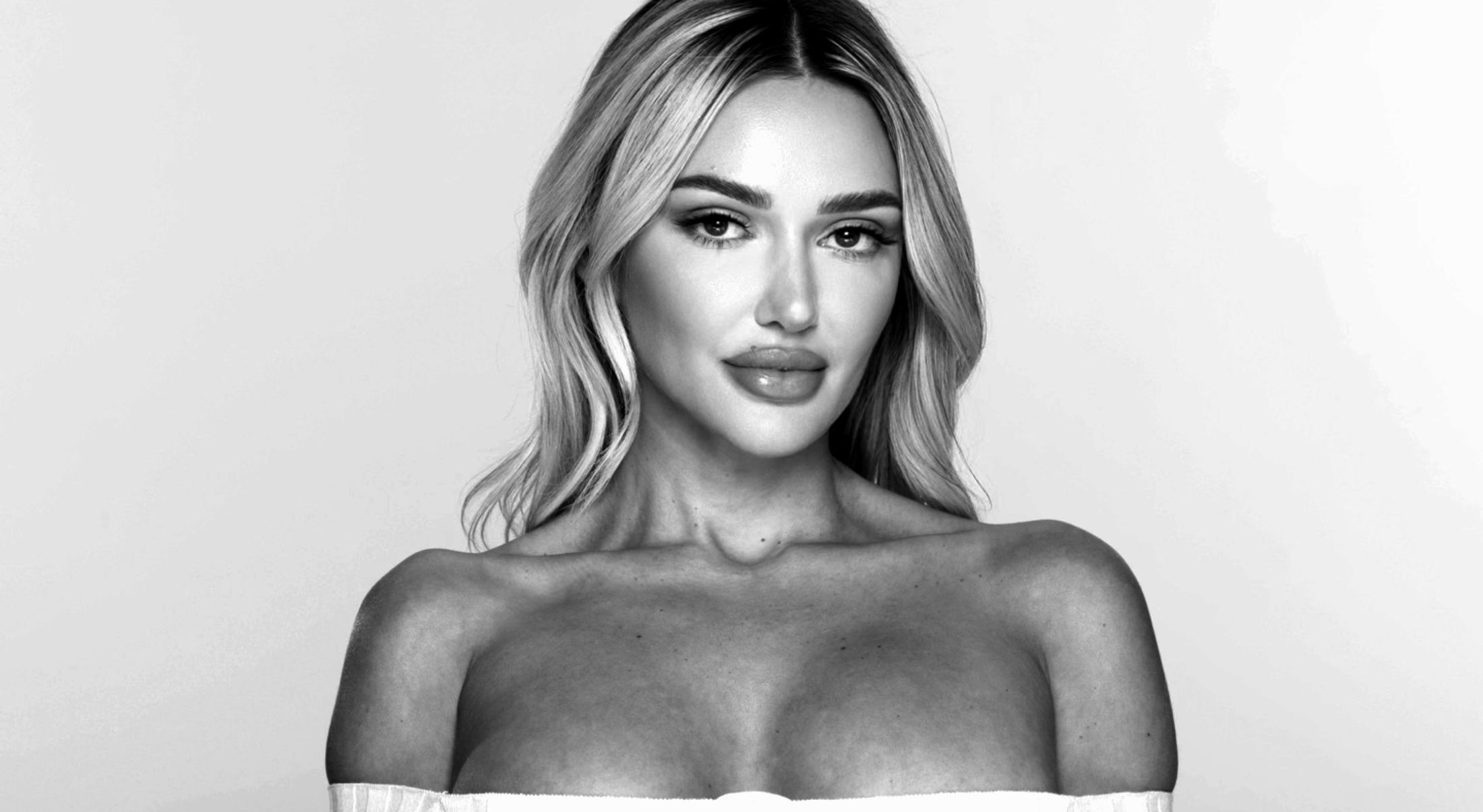 botox patient model with full lips in a low cut top